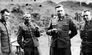 DrJosef Mengele, left, with Rudolf Hoss, Commandant of Auschwitz, Josef Kramer, Commandant of Belsen and a German officer.