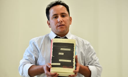 Yahdih Ould Slahi, the younger brother of Guantánamo Diary author Mohamedou, poses with a copy of the book during an event in London.