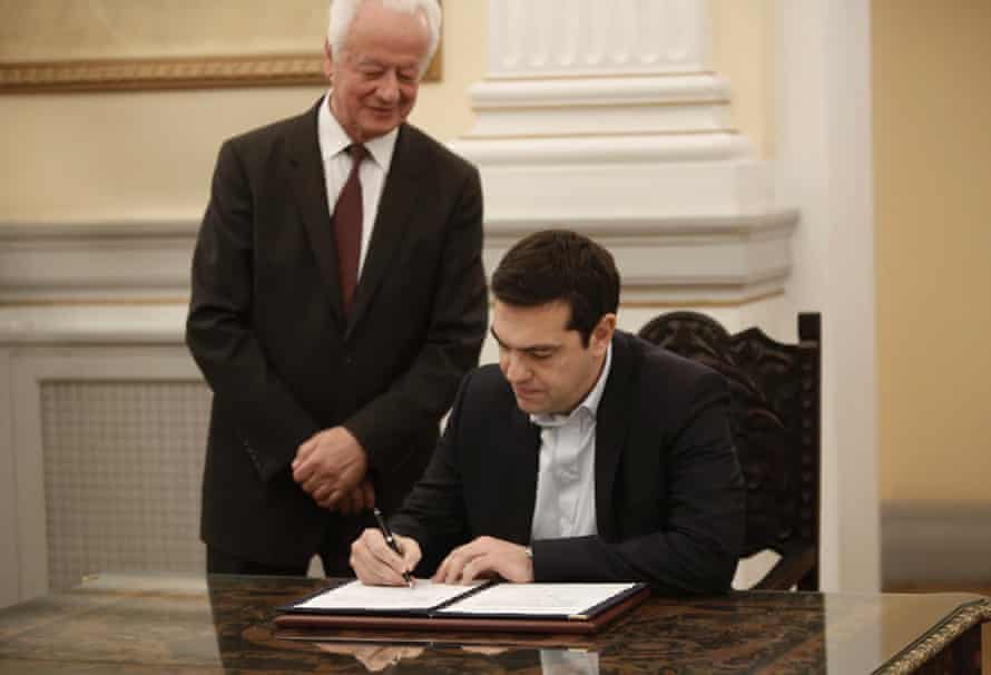 Greek radical leftist party SYRIZA leader Alexis Tsipras (R) signs protocols after his swearing-in as Prime Minister by the President of Republic Karolos Papoulias (unseen) at the Presidential Palace in Athens, Greece, 26 January 2015.