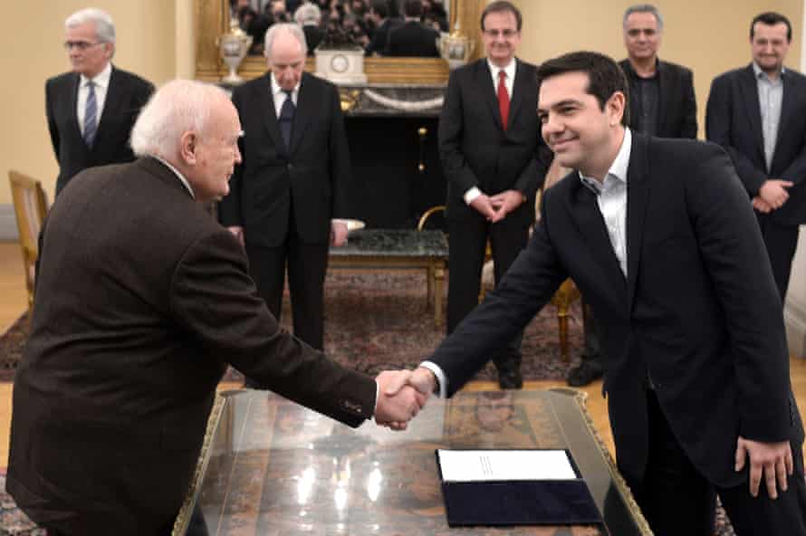 Greece's Prime Minister Alexis Tsipras is sworn in with Greek President Karolos Papoulias at the Presidential Palace on January 26, 2015 in Athens, Greece. Alexis Tsipras was sworn in with a secular oath, rather than the traditional Greek Orthodox ceremony, becoming the youngest man to hold the post of Prime Minister in 150 years..