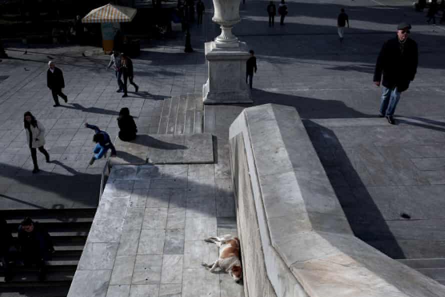 People walk outside a metro station at Syntagma Square in Athens.