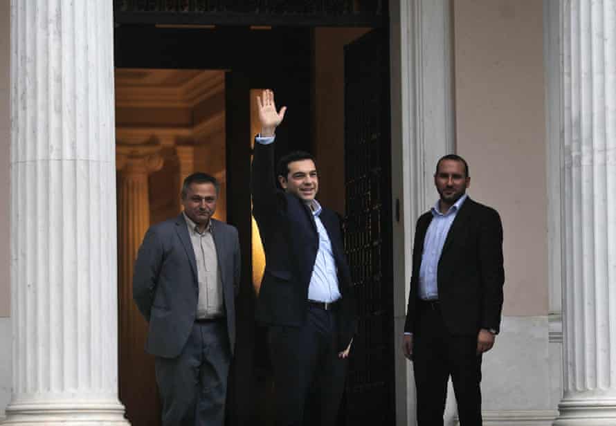 Greek radical left SYRIZA leader and newly sworn-in Greek Prime Minister Alexis Tsipras (C) waves to spectators and media as is on his way to enter the Prime Minister's offices, the Maximos Mansion, in Athens, Greece, 26 January 2015.