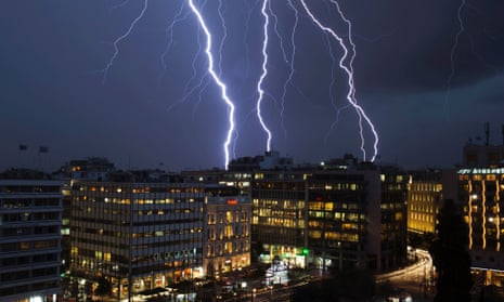 Lightning strikes over buildings at central Syntagma square during heavy rainfall in Athens.