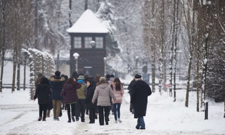 Visitors walk around the former Auschwitz camp on Monday.