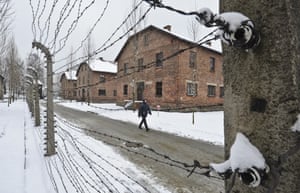 A visitor walks past a barbed-wire fence. A decade ago, 1,500 Holocaust survivors travelled to Auschwitz to mark the 60th anniversary of the concentration camp’s liberation. This time, organisers are expecting 300, the youngest in their 70s