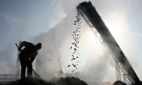 File photo shows a labourer working at a coal factory in Baicheng county