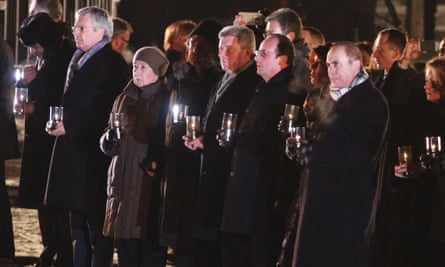 François Hollande holds a candle during a ceremony on the site of Auschwitz-Birkenau.