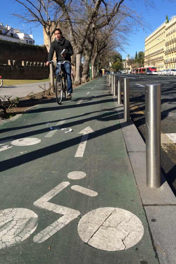 Seville's cyclists are often protected from cars by a kerb and a fence