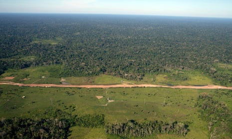 A newly constructed road goes through the Amazon rainforest outside Rio Branco, the capital of Acre Province, Brazil. For every 40 meters or road created, around 600 square kilometers of forest is lost, 21 June 2011.