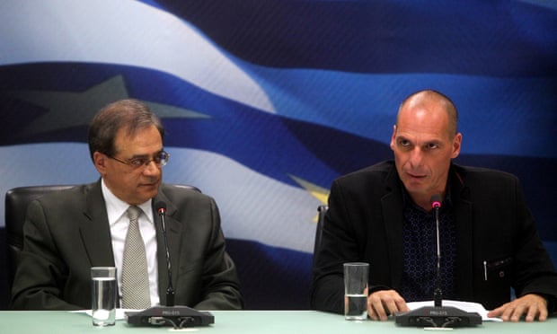 Greece's new finance minister Yanis Varoufakis (right) and outgoing finance minister Gikas Hardouvelis during the handing over of the reins to the finance ministry.