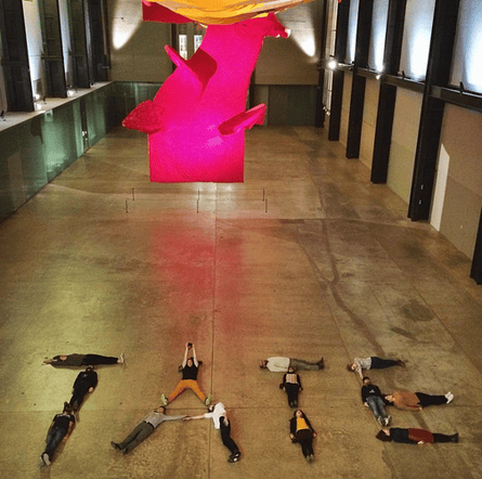 participants at the #emptytate event lie on the floor of the Tate Modern's Turbine hall spell out the word T-A-T-E