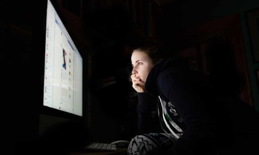 teen girl looking at facebook