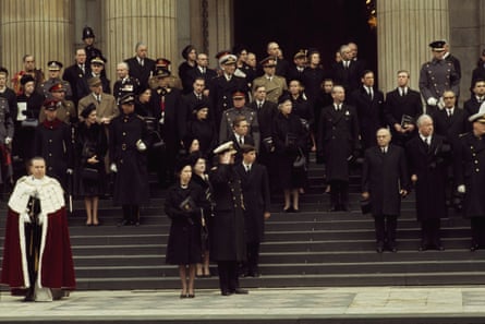Queen Elizabeth II stands with dignitaries on the steps as the casket leaves