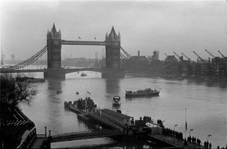 The funeral barge carrying the coffin moves into mid-stream off Tower Pier, London, for the journey up the Thames to Festival Hall Pier and Waterloo Station