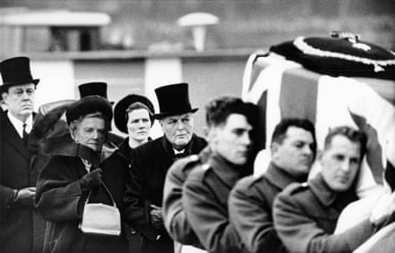Lady Clementine Churchill (1885 - 1977, second from left) is escorted on the arm of her son Randolph (1911 - 1968) as they follow the coffin