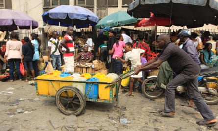 A man push cart with water at a market in Obalende  Lagos, Nigeria, Saturday, Jan. 14, 2012.  Nigeria's government will meet with labor unions in a last bid to halt a paralyzing national strike that now threatens oil production in Africa's most populous nation. 