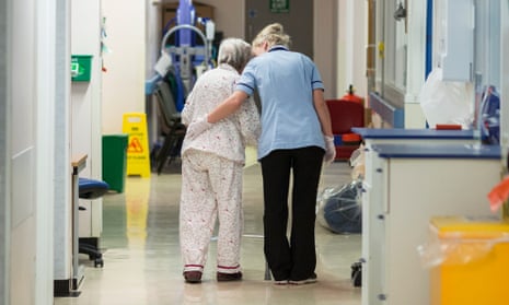 A health worker and patient on a ward in Addenbrooke, one of the hospitals which refused to sign off the NHS budget deal.