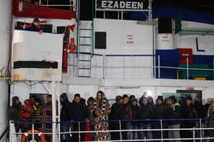 Migrants on the deck as the ship docks in Italy.