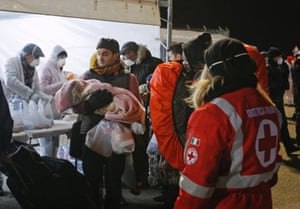 Medics help migrants after they disembark.