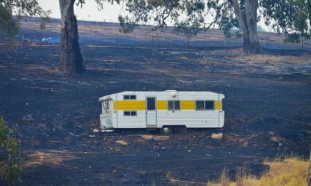 A caravan saved from the fire sits on charred earth near One Tree Hill in the Adelaide Hills.