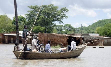 Fishermen transport villagers with their belongings across floodwaters in Phaloni, southern Malawi, Thursday, Jan 22, 2015. Malawi has been affected by flooding caused by heavy rains, with scores of people having died and some 200,000 displaced.
