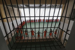 Inmates pray before a soccer match in the complex