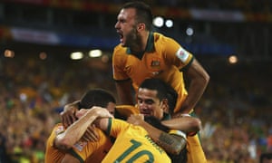 Ivan Franjic joins the swarm of Socceroos mobbing Massimo Luongo after the opening goal.