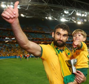 Mile Jedinak celebrates with his biggest (and littlest) fan.