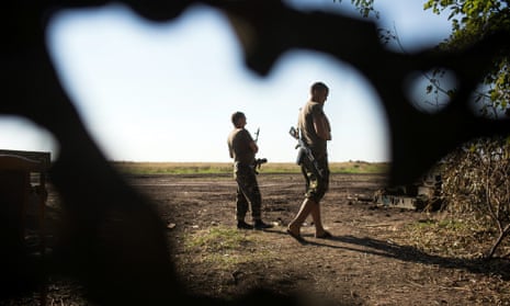 Ukrainian soldiers patrol near their military camp close to Luhansk, Ukraine, in August 2014.
