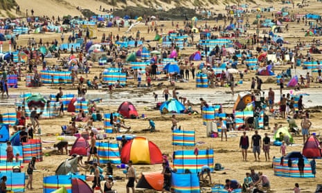 Holiday makers enjoying sunny beach weather at Woolacombe beach, North Devon, as 2014 was the UK's warmest year on record.