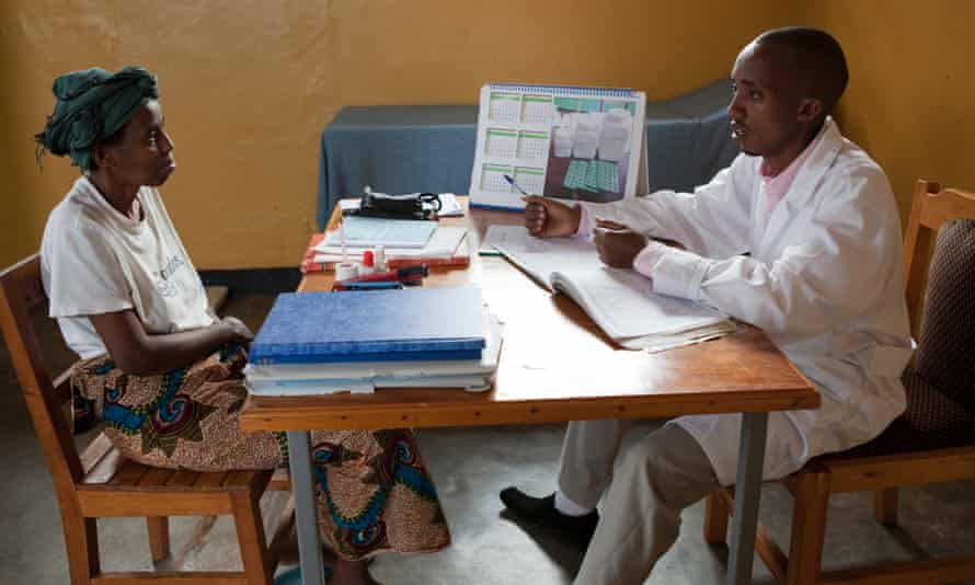 A doctor explains treatment procedure to a patient in Butare, Rwanda.