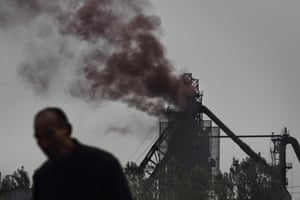 Han Jingcai from Duliugu Village is tending to his vegetable field, just 100 m away from a blast furnace belonging to YongYang Steel Co plant in Yongnian county in Handan. His hands are caked in blackish pollution that has drifted over from the furnace. That thick brown smoke is coming from the blast furnace.