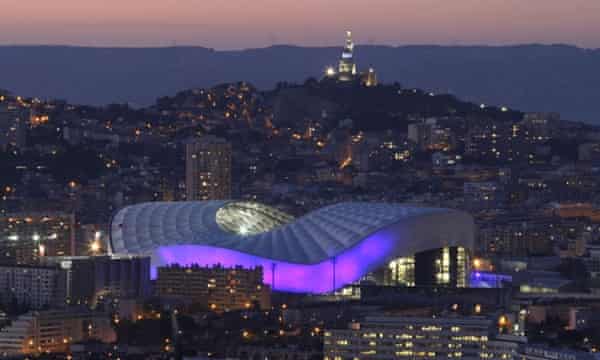 The Stade Vélodrome in Marseille, with Notre Dame de la Garde basilica in the background.