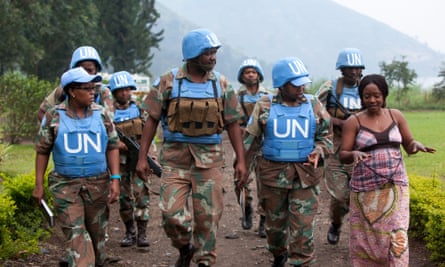 Major Steven Matodon, public information officer for the South African U.N. brigade, center, leads a handpicked group of mostly female U.N. soldiers on a "mission" to scope out a park to hold an upcoming Women's Day celebration, near Sake, D.R. Congo, July 26, 2014.   They are treating us as women whereas we are soldiers,  says Lieutenant Colonel Zukiswa Caga, the brigade's gender advisor, third from right.