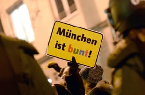 A protester holds a sign reading 'Munich is colourful' in Munich