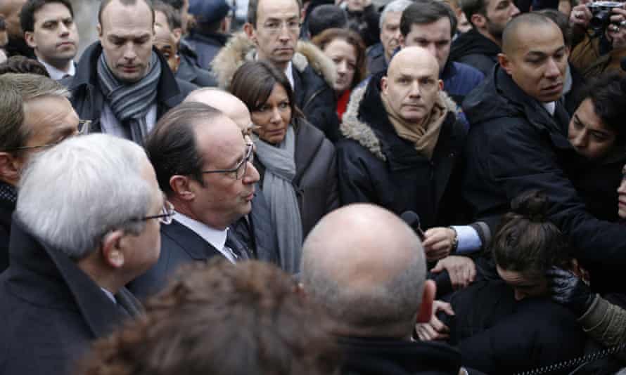 Hollande speaks to the press after arriving at the offices of Charlie Hebdo.