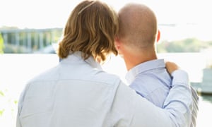 Two gay men standing by water's edge