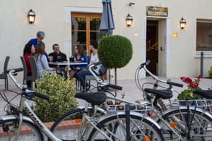 Cyclists on the terrace of a hotel in Sully-sur-Loire, France, which has Accueil Vélo (cycle friendly) accreditation.