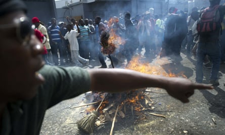 Demonstrators perform a voodoo ceremony prior to a protest against the government of President Michel Martelly, in Port au Prince, on November 25, 2014. Protesters marched through the streets calling for the resignation of the Haitian leader.