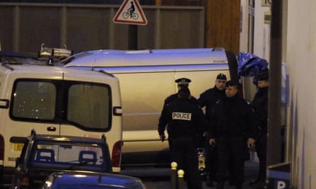 French police  stand next to funeral hearse in front of the entrance of the Paris offices of Charlie Hebdo.
