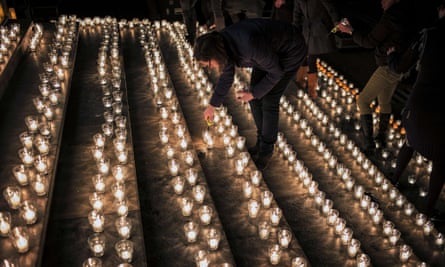 A woman lights a candle during a vigil in Lyon following an attack on Charlie Hebdo.