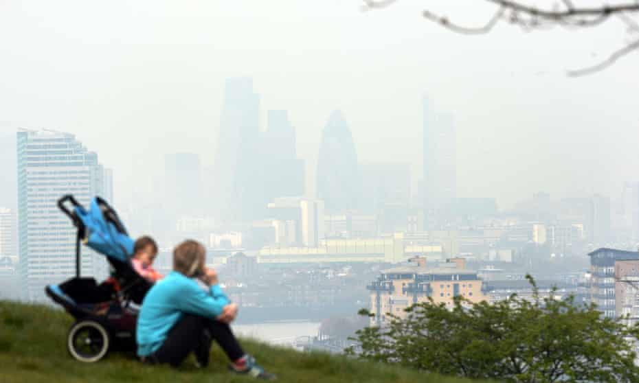 Dust particles and pollution from cars hangs over London, seen from Greenwich, as people suffering the effects of high levels of pollution - including sore eyes, coughs and sore throats - should cut down the amount of activity they take outside, experts have warned on April 2, 2014.