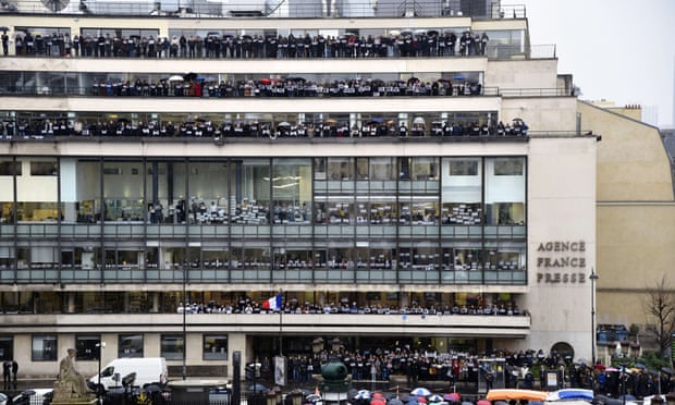 Journalists of Agence France-Presse (AFP) observe a minute of silence.
