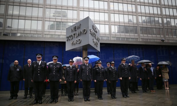 Members of the Metropolitan police observe two minutes silence at New Scotland Yard.