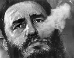 Fidel Castro exhales cigar smoke at his presidential palace in 1985.