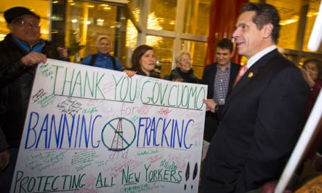 New York Governor Andrew Cuomo (R) greets fracking protesters outside his office in New York December 17, 2014. Protesters were celebrating today's announcement by Cuomo's administration to ban hydraulic fracturing in the state of New York after a long-awaited report concluded that the oil and gas extraction method poses health risks.