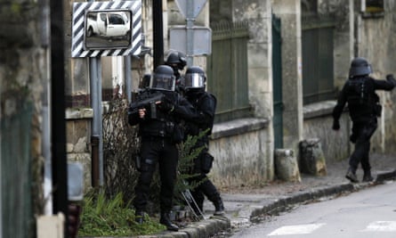 SWAT police officers patrol in the village of Longpont, north-east of Paris, in search of the suspects