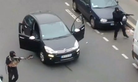 Gunmen flee the offices of Charlie Hebdo magazine in Paris.