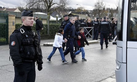 French gendarmes stand by as children are evacuted from a school in Dammartin-en-Goele, north-east of Paris, where two brothers suspected of slaughtering 12 people in an Islamist attack on French satirical newspaper Charlie Hebdo held one person hostage as police cornered the gunmen.