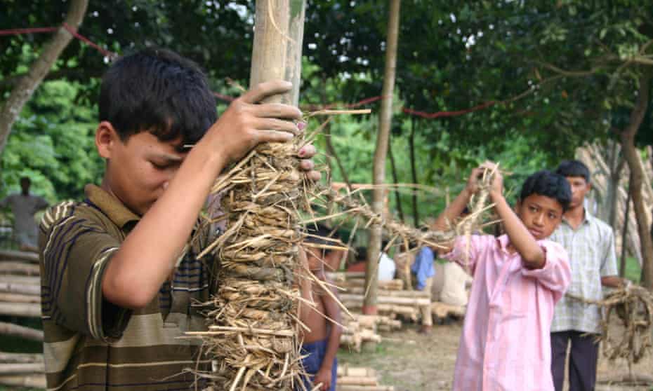 Child helping to make the METI handmade school in Bangladesh.